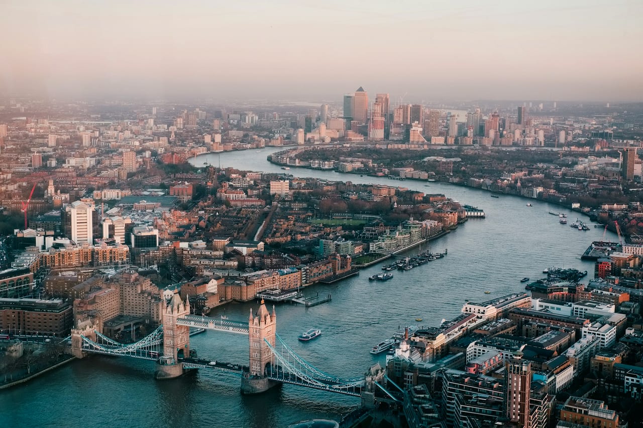 Aerial view of London — Tower Bridge and the Thames winding toward the City